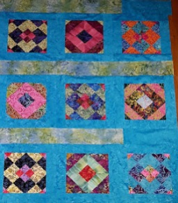 Batik Quilted Blanket - by AmyScrapSpot - https://amyscrapspot.blogspot.com/2016/11/batiks-quilt-top-finished.html